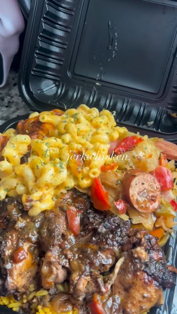 Jerk chicken with baked mac and cheese and cabbage with sausage